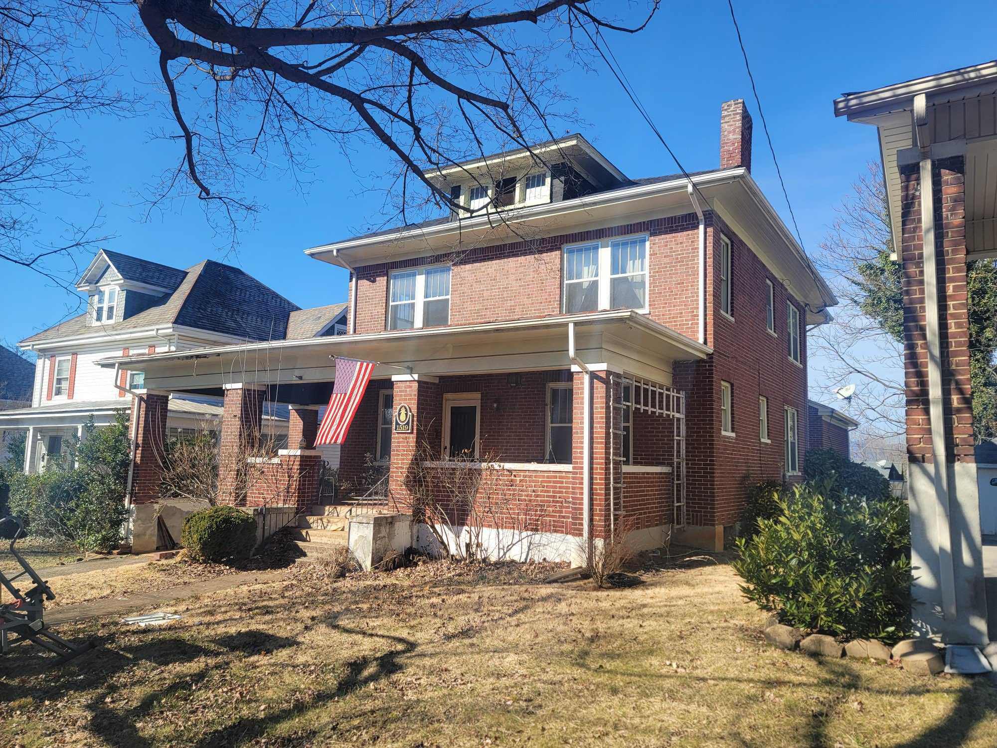 a view from below of a porch on an unmaintained home